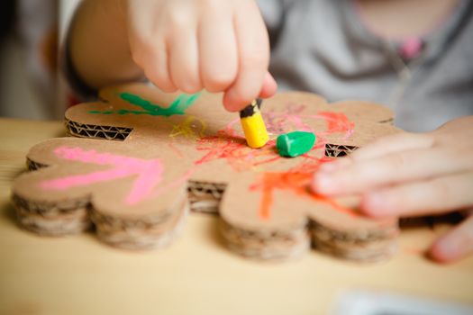 Little female baby painting with colorful paints. selective focus