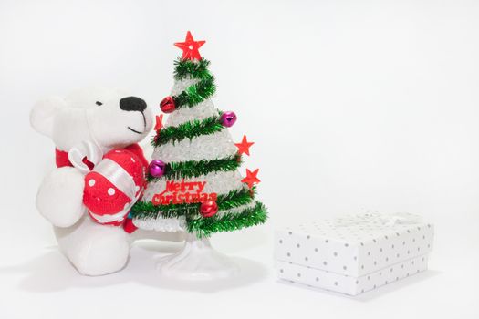 White teddy bear with christmas tree on the white background.