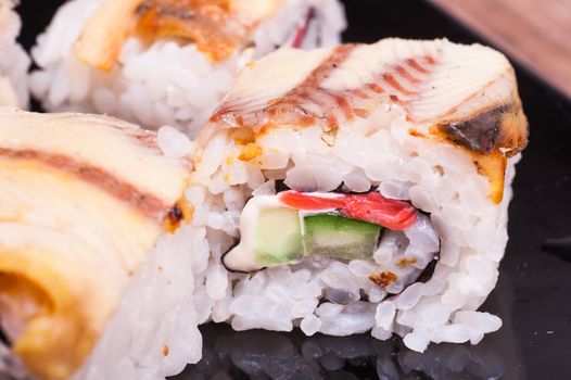 eel sushi roll set on wooden background 