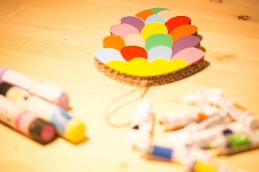 Colorful toys made of cardboard on a wooden table. Creative background