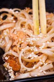 asian fried udon noodles on wooden background