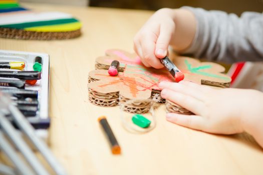 Little female baby painting with colorful paints. selective focus