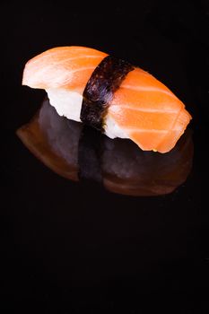 salmon sake nigiri isolated on black background