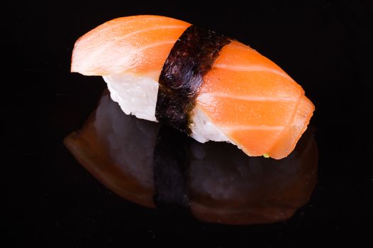 salmon sake nigiri isolated on black background