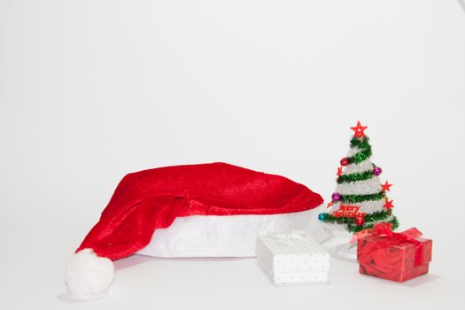 Santa Claus hat with christmas tree and gifts
