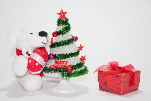 White teddy bear with christmas tree on the white background.