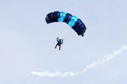 the parachutist goes down on a multi-colored parachute