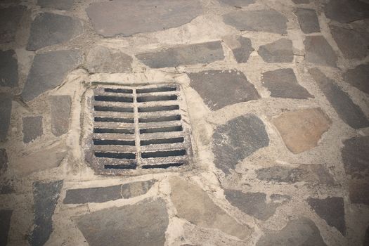 gully on old town street, urban pedestrian road