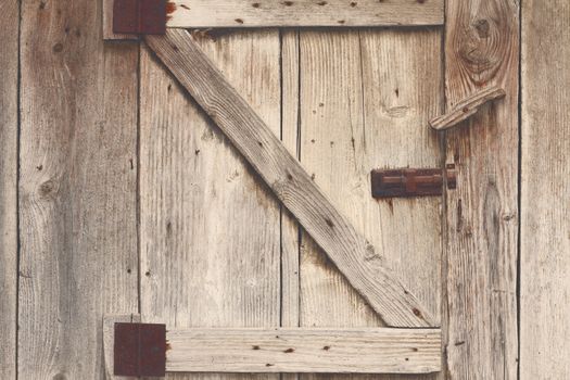 wooden barn door detail, textured view with vintage effect