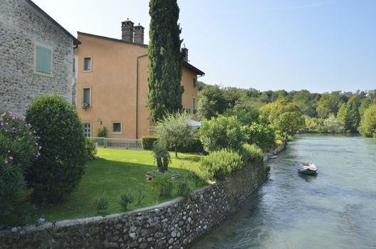 Boat  in the river Mincio in Borguetto, a ancient village  in the municipality of Valeggio, in the province of Verona; Italy.