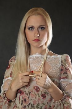 Beautiful young blond woman portrait looking at camera.