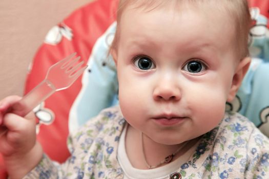 Little girl with fork in hand