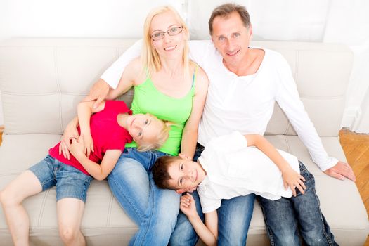 Happy family sitting together on the couch
