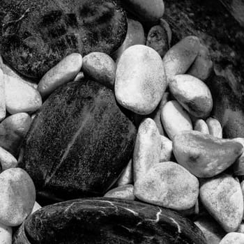 Close up of black and white pebles mixed together.