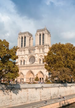Notre Dame in paris, exterior view on a cloudy day.