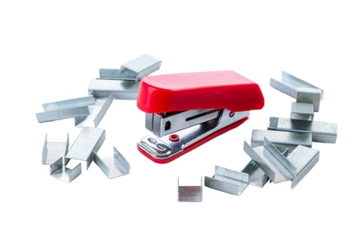 A mini red stapler on a white background and surrounded by the small staples used in this size stapler.