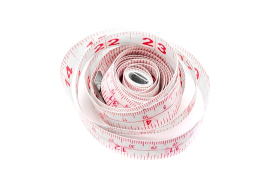 White and red measuring tape curled up and lying on a white background.