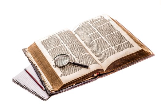 Old Dutch bible on an isolated white background, with a magnifying glass on top of the open bible, and a modern notebook and pencil on the left of the bible.







Old Dutch Bible