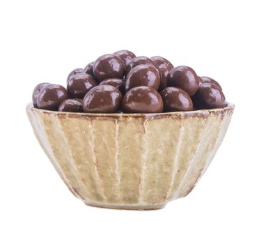 chocolate balls. chocolate balls in bowl on a background.