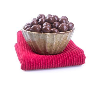 chocolate balls. chocolate balls in bowl on a background.