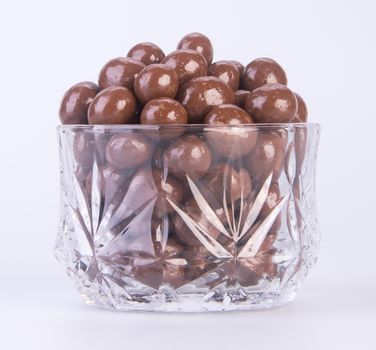 chocolate balls. chocolate balls in bowl on a background.