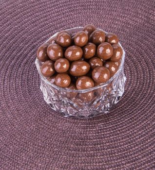 chocolate balls. chocolate balls in bowl on a background.