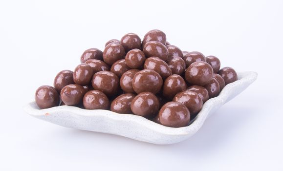 chocolate balls. chocolate balls in bowl on a background.