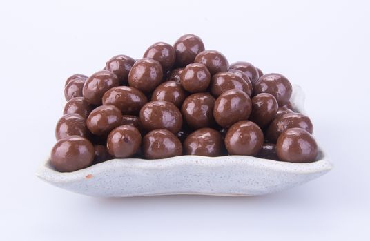 chocolate balls. chocolate balls in bowl on a background.