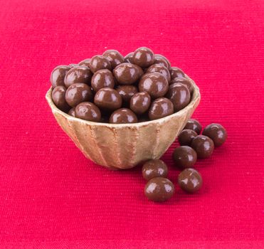 chocolate balls. chocolate balls in bowl on a background.