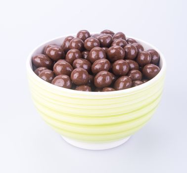 chocolate balls. chocolate balls in bowl on a background.