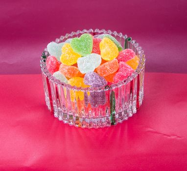 candies. jelly candies in glass bowl on a background.