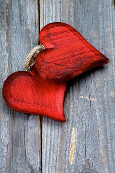 Two Wooden Red Hearts isolated on Rustic Wooden background