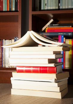 Books over table with library on the background