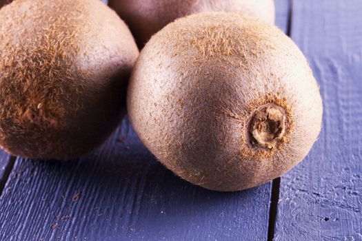 Some Kiwis over wooden background, horizontal image