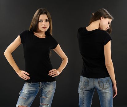 Photo of a beautiful brunette woman with blank black shirt over black background. Ready for your design or artwork.