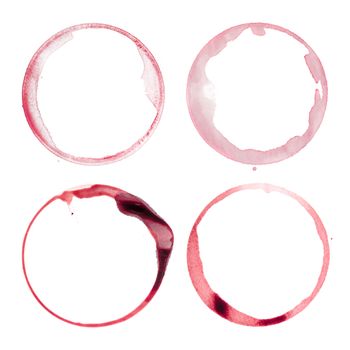 Photo of four different red wine stains from wine glasses on white background.
