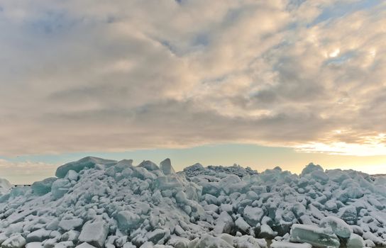 Sunset sky and broken ice on Ladoga Lake, Russia.