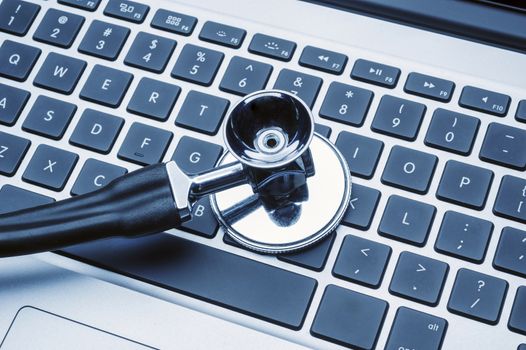 A stethoscope on a computer keyboard used by modern doctors