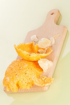 Parmesan cheese basket and parmigiano pieces on wooden kitchen board isolated. Culinary cheese eating. 