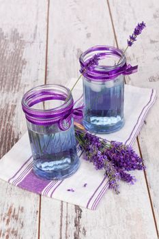 Lavender lemonade on white wooden textured background. Homemade healthy refreshing drink.