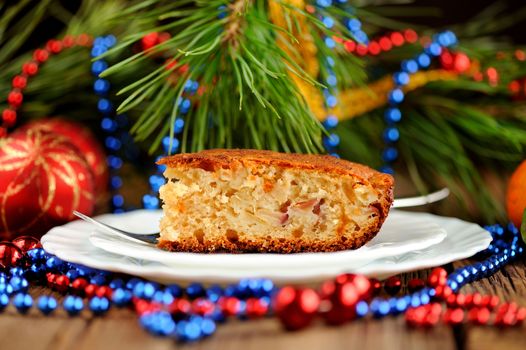 Christmas cake on white plate with fur tree and christmas toys horizontal