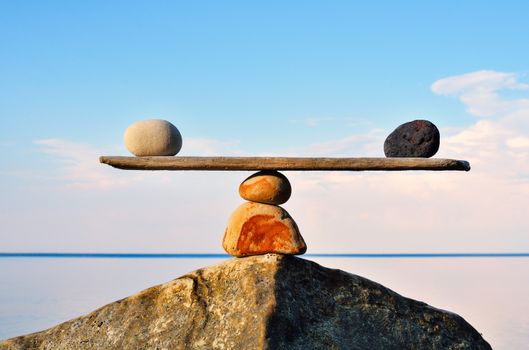 Balancing of pebbles on the top of stone