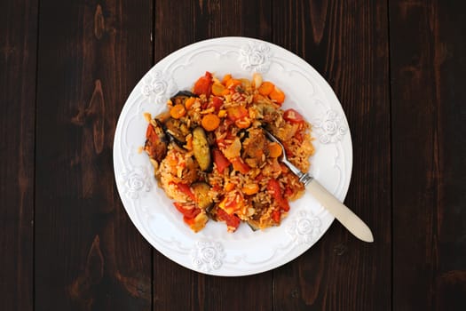 Aubergine ragout with tomatoes on dark wooden background