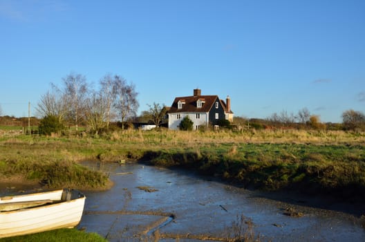 Isolated cottage by creek in winter