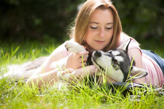 Young woman and her husky in the forest