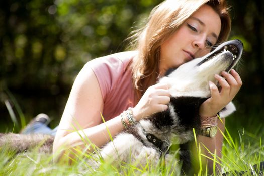 Young woman and her husky in the forest