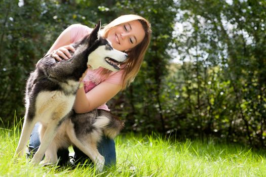 Young woman and her husky in the forest