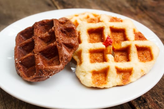 fresh waffle on white plate at restaurant.