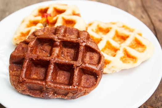 fresh waffle on white plate at restaurant.