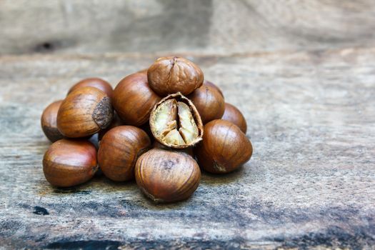 sweet chestnut on wood background, food.